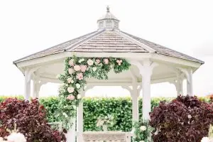 Wedding Ceremony Gazebo with pink peonies and foliage | Essex Wedding Planner