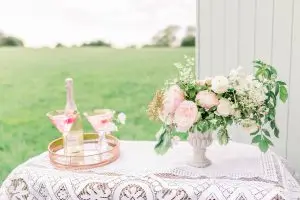 Lace Tablecloth with urn of flowers and two pink cocktails | Essex Wedding Planner