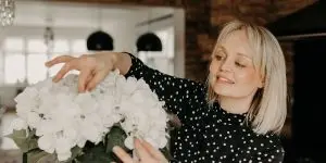Essex wedding planner Hayley Jayne arranging flowers at wedding