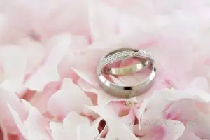 Wedding Rings On Pink Petals | Essex Wedding Planner