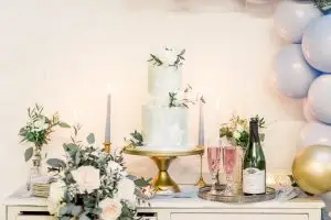 Wedding cake with bouquet & bottle of fizz | Essex Wedding Planner