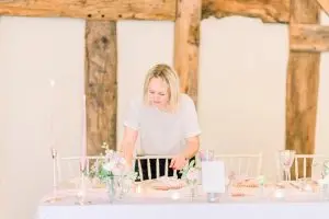 Hayley Jayne Weddings & Events setting up a wedding table | Essex Wedding Planner