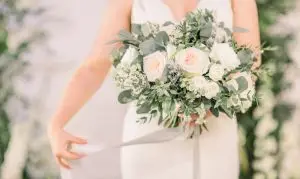 Bride holding her wedding bouquet with cascading silk ribbon